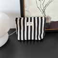 Minimalist black and white striped fabric toiletry bag with beige label tag - Black