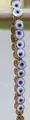 Adjustable evil eye charm bracelet with blue and gold enamel circular beads - White