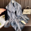 Detail view of a long grey silk scarf with navy wave patterns and sheer texture - Gray Waves / 180CM-130CM