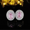 Macro shot of oval pink gemstone earrings with double halo diamond detail and silver base - Oval Pink Style (E667)