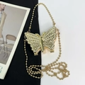 Sparkling gold butterfly clutch bag with rhinestones and bead chain on fashion background - Gold