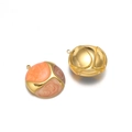 Golden round earrings with orange brown enamel swirl patterns on white background - Orange Brown Coffee