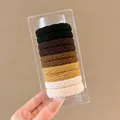 Neutral earth tones elastic hair ties set in clear container held by hand - 10 Pieces in Box / 2# Milk Coffee Ribbed