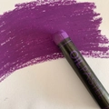 Single deep purple oil pastel showing high saturation texture on white paper - Purple