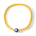 Handmade bracelet with bright yellow seed beads and a blue evil eye lucky charm - Bright Yellow