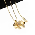 Elegant gold bow pendant necklace with shimmering zircon stones and a classic box chain - Pendant And Necklace (7)