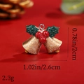 Macro shot of glittery Christmas bell pendant with size dimensions 2.6cm by 2cm - Bell with Green Leaves and Bow