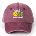 Detail view of washed cotton baseball cap with JUST ONE MORE GAME embroidery and pickleball - Burgundy