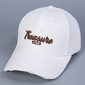 Close-up of white cotton baseball cap featuring 3D Treasure embroidery and distressed brim - White