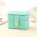 Portable mint green PU leather jewelry travel case with secure gold button closure - Blue