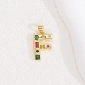 Macro detail of gold letter F pendant featuring colorful inlaid zircon gemstones - Letter F