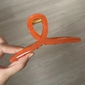 Orange oversized plastic hanger hair claw clip with golden metal spring held by hand - 13cm Hanger Type / Sandalwood Orange