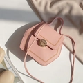 Pink hexagonal crossbody bag with lychee texture and golden circular lock detail - Pink