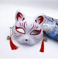 Detail of Japanese fox mask with red hand-painted patterns, tassels and small bells - Red W Style