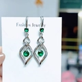 Silver hollow diamond earrings with emerald stones and zircon accents on a display card - Green Diamond Teardrop Hollow Earrings Led-75