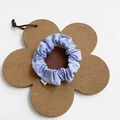 Light blue fabric scrunchie with brand label on floral cork coaster display - Small / Light Blue