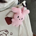 Cute pink plush rabbit keychain charm hanging on a beige canvas bag shoulder strap - Keychain / Pink
