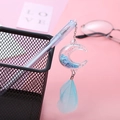 Cute light blue gel pen with moon-shaped liquid glitter charm and feather pendant detail - Moon Blue