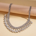 Detail of luxury geometric rhinestone necklace with fringe fringe on pink cylinder display - Silver