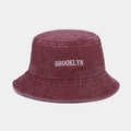 Detail of Brooklyn embroidery and breathable metal eyelets on a burgundy bucket hat - M (56-58cm) / Burgundy