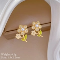 Detail of floral earrings with gold base, white pearl centers, and green enamel leaves - Flower Stud Earrings (D154)