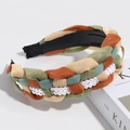 Detail of woven mesh headband with white pearls on a minimalist book background - Pearl Braided Colorful Mix