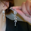 Elegant silver tassel earrings featuring leaf-shaped zircon crystals on female model - 42# Silver Earring Post - Silver - High Quality Copper
