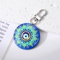 Detail of bohemian round evil eye mandala keychain with silver metal lobster clasp and ring - Large Blue Floral Eye