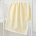 Thick cream cotton towel with gold crown embroidery on a minimalist white hanging rack - Cotton Crown Cream (Towel)