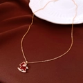 Macro detail of red enamel horse pendant with small diamonds and 18K gold-plated chain - Rocking Horse Necklace / Gold-Red