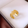 Macro detail of vintage gold hollowed-out ring with sparkling zircon in a jewelry box - Vintage Hollow Rhombus Style / Gold