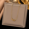Luxurious gold bead necklace with four gradient polished beads on a premium display - 23456 Beads / Gold