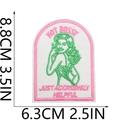 Detail of NOT BOSSY embroidered patch with pink border and size metrics 8.8x6.3cm - Style 9 (AGGRESSIVELY HELPFUL)
