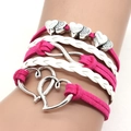 Close-up of pink suede and white braided leather infinity heart bracelet on wrist - Rose Red Heart Braided Bracelet