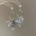 Detailed silver leaf tassel earrings with cubic zirconia on a transparent display stand - Silver Leaf Zircon