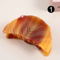 Amber tortoiseshell acetate claw clip with textured wave pattern in a crescent shape - Amber Wave Pattern (H661)