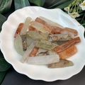Detail of natural mixed crystals and colorful stone pendants in a white ceramic dish - Red Rhodonite