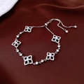 Macro shot of silver checkerboard bracelet with zircons on dark velvet background - Silver-Black