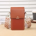 Brown mini crossbody phone bag with leaf buckle and geometric woven strap in a cozy setting - Brown