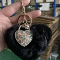 Black plush heart keychain with gold heart pendant featuring pink and green beads - Black