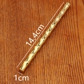 Detailed view of bamboo-shaped brass pen on a dark wood surface with elegant engraving - Bamboo Pen (Jin Bang Ti Ming) / Gold