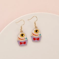 Halloween drop earrings featuring a creative purple eyeball cupcake with red bow - Eyeball Cupcake