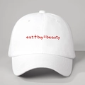 Witte katoenen baseballpet met rode Eat Buy Beauty slogan en verstelbare gebogen rand - Eén maat / Wit