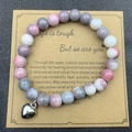 Pink zebra stone bead bracelet with a silver heart charm on a brown display card - Pink White Gray Zebra