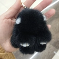 Cute black cat paw plush keychain charm with soft fur and golden metal details - 8cm / Black