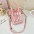 Detail of pink and white knitted phone bag with 'BECOMINGRICH' text and woven shoulder strap - 12-Pink and White-Becoming Rich