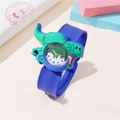Kids slap watch featuring green dinosaur case and blue strap on a minimalist desk - T-Rex