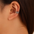 Detailed macro view of a vintage silver ear cuff featuring an intricate turtle relief design - Ancient Silver (8355)