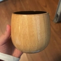 Hand holding a round carbonized wooden cup with natural grain for tea or whiskey - 300ml / Extra Large Charcoal Finish Light Wood Belly Cup