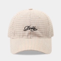 Close-up of beige plaid baseball cap featuring black cursive Done letter embroidery - Adjustable / Beige